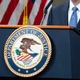 The seal of the U.S. Department of Justice as Attorney General Merrick Garland addresses staff on his first day in March 2021.